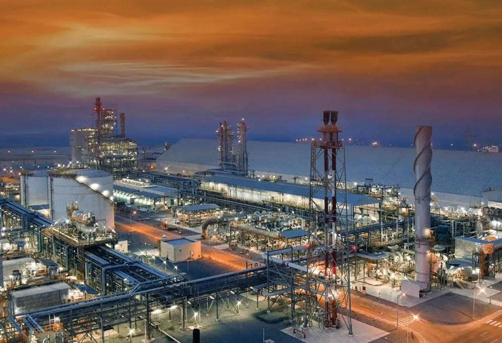 Aerial view of a petrochemical plant illuminated at dusk